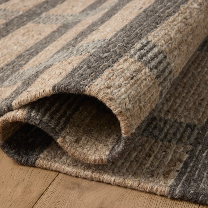 Hand-woven wool rug on oak flooring